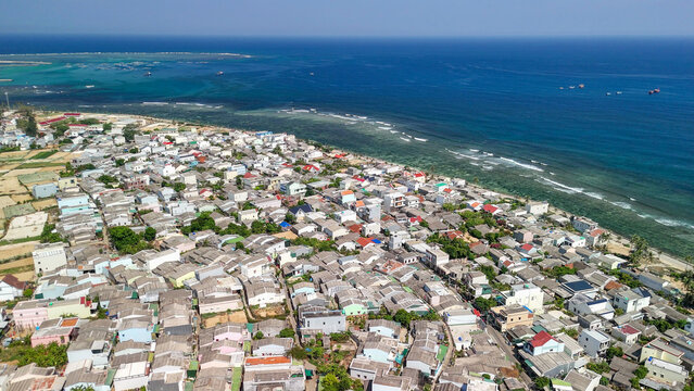 Aerial perspective of tropical sea and volcanic rocks on southern coast of Ly Son