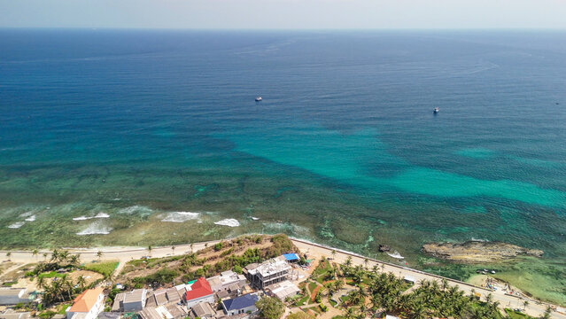 High angle drone shot of Ly Son southern coastline bathed in sunlight