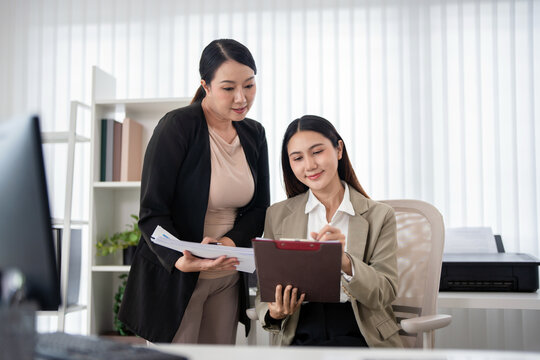 A young businesswoman is presenting a report to her senior colleagues in the office.