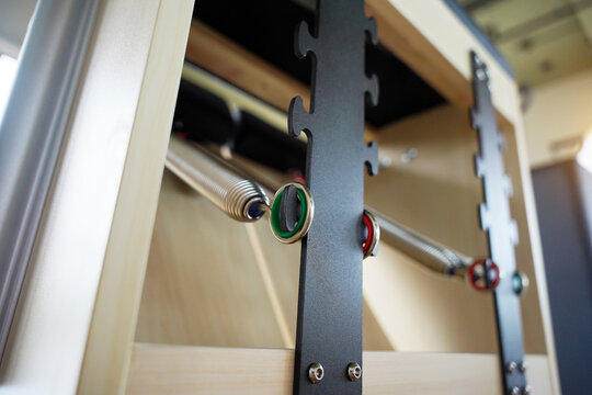 Close-up of pilates reformer studio with aligned machines for fitness group workouts