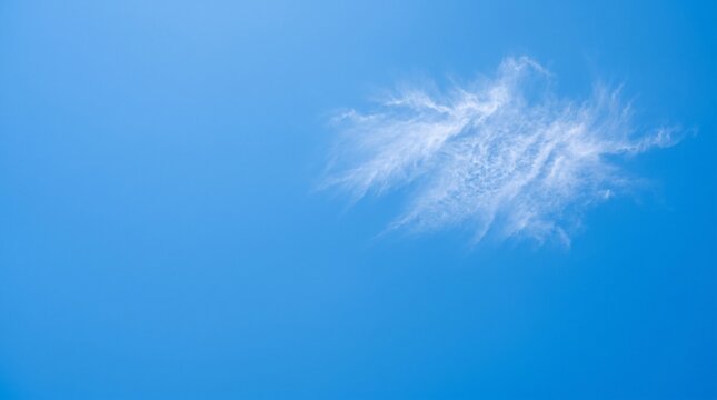 Bright blue sky with wispy clouds forming natural abstract pattern