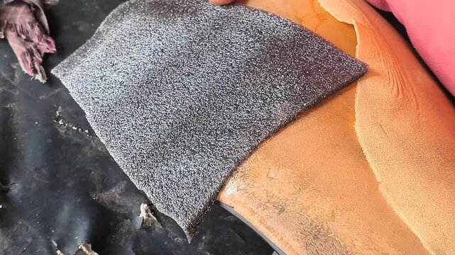 Close Up of Craftsman Placing Cushion Padding Patch on Damaged Scooter Seat Foam