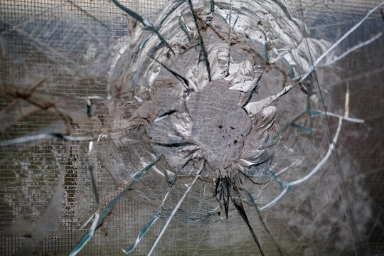 Window shattered by a shell fragment in Severnaya Saltovka district in Kharkiv, consequences of the war in Ukraine