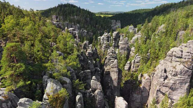 Aerial view of famous Adrspach Teplice rocks emerging from dense pine forest in the Czech Republic. Massive sandstone rocks in Adrspach nature reserve. Teplice national park