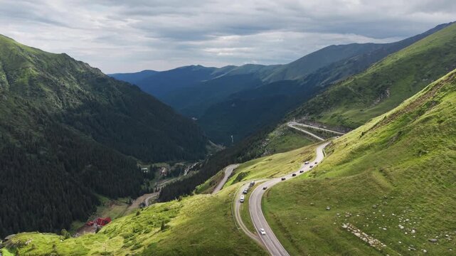 Cars Following Sunlit Transfagarasan Hairpins