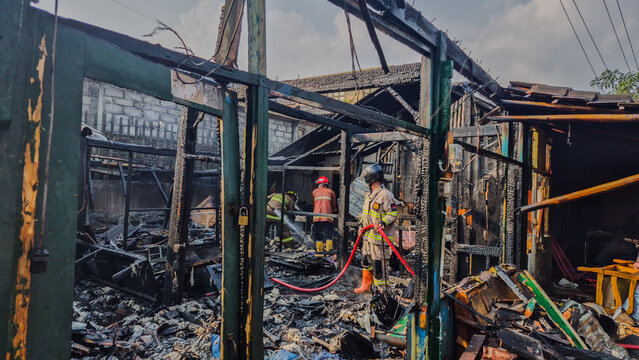 Indonesian firefighters are carrying out cooling-down operations at a building that was gutted by fire