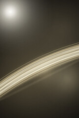 A luminous golden arc sweeps across a deep charcoal field, creating a refined cosmic mood suitable for technology branding, astronomy themes, presentations, and elegant web layouts. © Bonya Sharp Claw