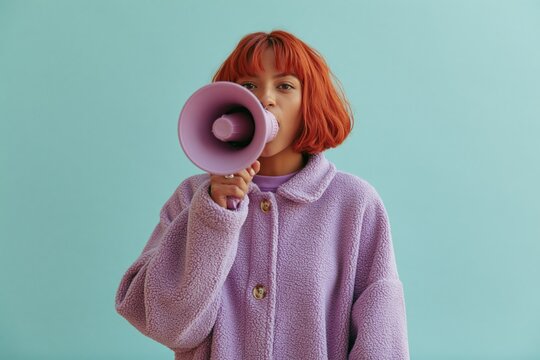 Young woman with megaphone announcing message in pastel purple coat for protest banner and poster design