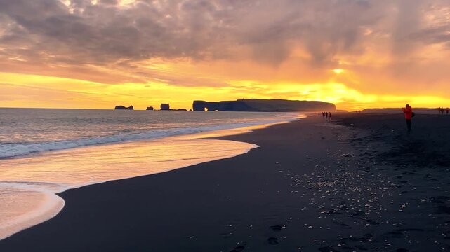 Dramatic Sunset Over Black Sand Beach and Ocean Waves in Iceland