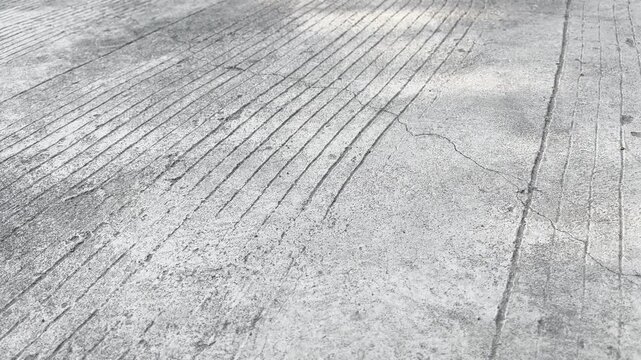 Cracked concrete road surface texture with grooved pattern