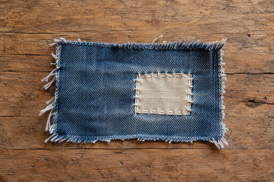 Denim patch with simple visible mending stitches