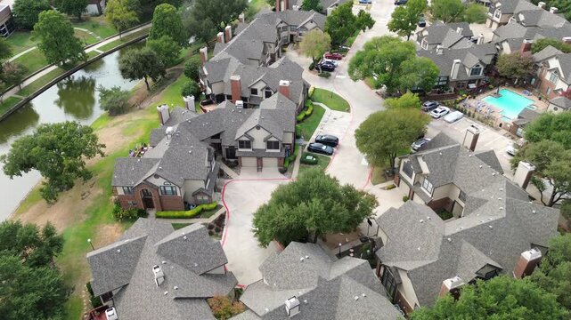 Dense clusters of modern townhomes showcase clean architectural lines near open green corridors. Master planned community design optimizes space throughout Valley Ranch, Valley Ranch, Irving, TX