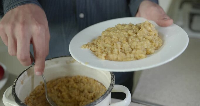 Close-up male hand put lentils on plate dish. 4K 10-bit