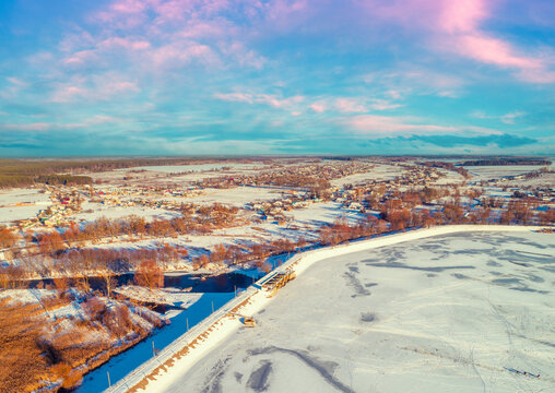 Aerial view of the frozen lake and dam in winter