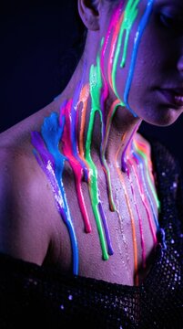 Woman with neon glowing paint dripping down her face and neck