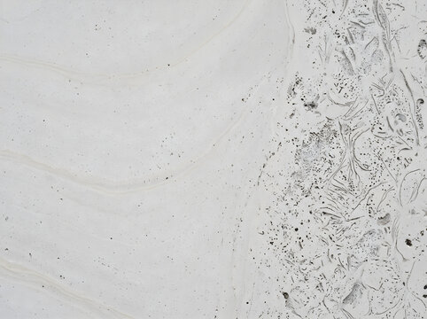 light gray stone texture with subtle veins and fossil specs