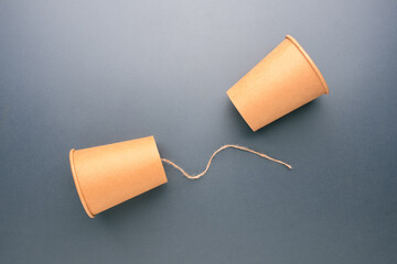 Obraz premium Disconnected Paper Cup Telephone Representing Communication Breakdown