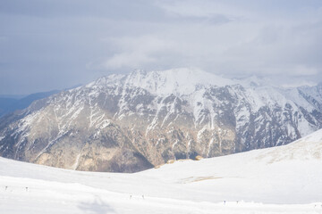 Obraz premium Winter landscape of Caucasus mountains under cloudy sky