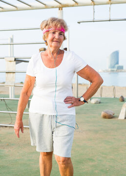 Old lady in outdoor workout station