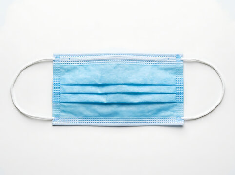 Blue disposable face mask with elastic straps on transparent background transparent background