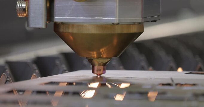 CNC Laser cutting of metal, modern industrial technology. Small depth of field. Warning - authentic shooting in challenging conditions.