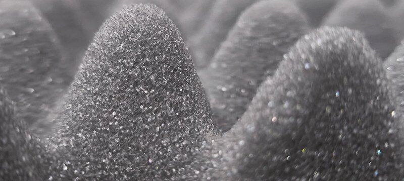 Materials that absorb sound waves instead of blocking them.