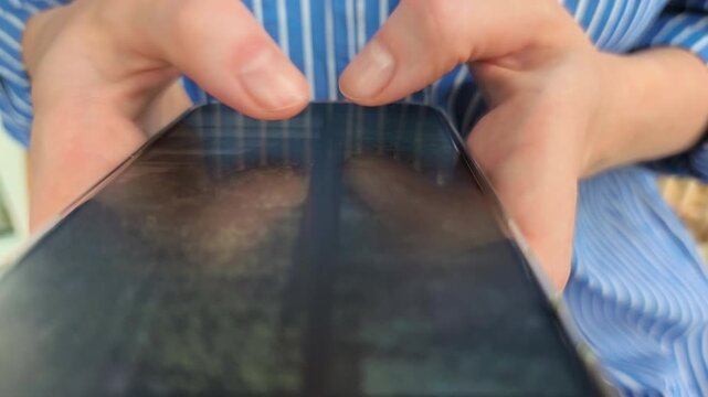 Photo gallery browsing routine performed by woman checking mobile application media portfolio. Female consumer scrolling photographic images on modern smartphone touchscreen display for