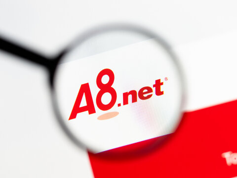 Milan, Italy 2026, 15 AGO Closeup of a8 net website page on a laptop screen. Focus on a8 net logo under a magnifying glass.