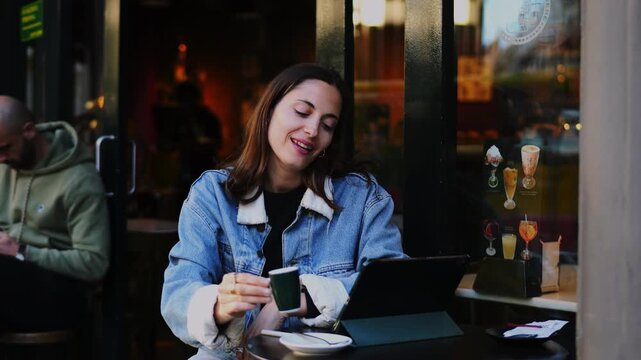 Drinking espresso coffee break Caucasian female remote work digital tablet on table thoughtful moment digital wellbeing outdoor cafe setting authentic representation real people lifestyle
