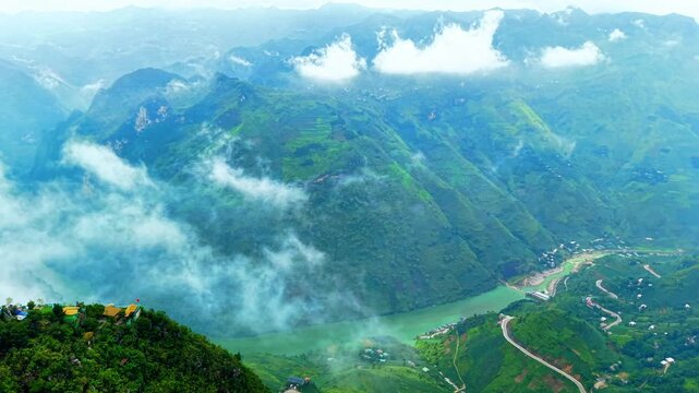 High aerial orbit above Tu San Canyon and towering cliffs descending to the Nho Que River