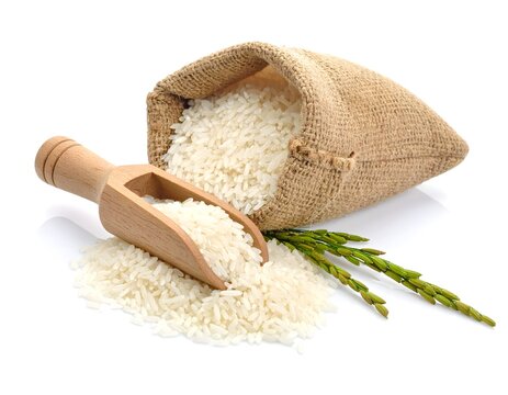 Rice jute sack bag and wooden scoop of rice on white background