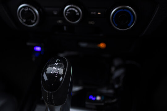 Close-up of modern car automatic gear shift knob with PRND markings,A detailed close-up shot of a modern car's automatic gear shift knob, featuring the clearly marked positions for Park, Reverse,