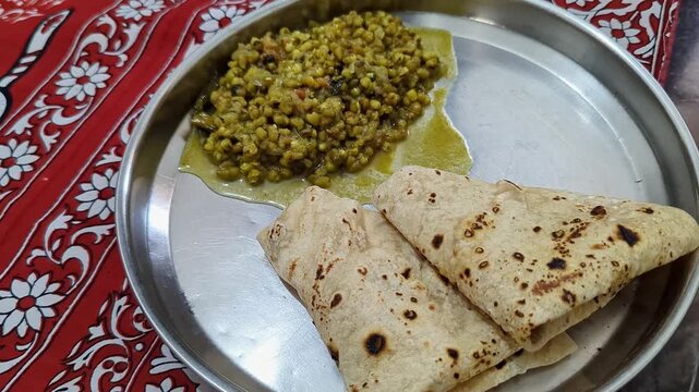 Closeup of warm soft rotis or flat bread served with nutritious sprouted moong on plate