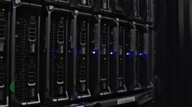 Close-up of Server Rack with Hard Drive Bays and Glowing LED Status Lights in a Modern Data Center Storage System