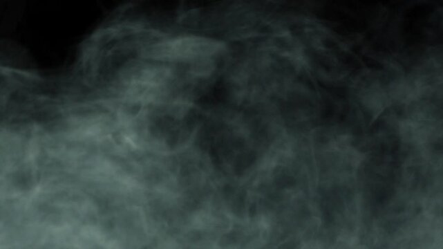 Smoke swirls in the light on the ground. Can be used as a special effect for your projects, video texture or background for designs, scenes, etc. Video in loop.