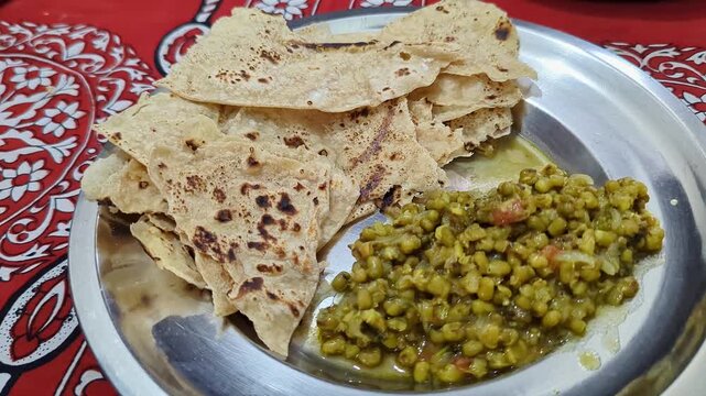 Closeup of warm soft rotis or flat bread served with nutritious sprouted moong on plate