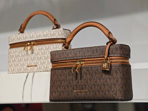 Shanghai, China-Jan.13th 2026: Close-up Michael Kors light and brown monogram vanity cases in store