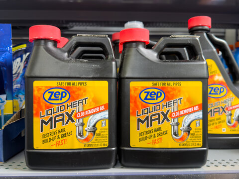 Frisco, Texas, USA - September 15th, 2026: Black plastic bottles of Zep liquid heat max clog remover gel with red caps arranged on retail store shelf