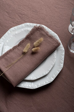 Elegant Brown Linen Table Setting with Fringed Napkin