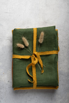 High angle view of a stack of folded green linen fabric