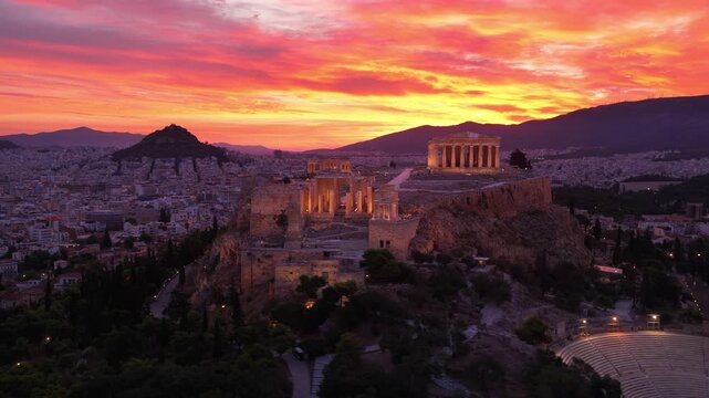 Dramatic sunrise drone view of Parthenon on Acropolis hill in Athens, capital of Greece, establishing shot of Acropolis hill with Ancient Greek ruins at dawn