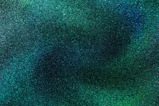 Green black glitter texture abstract banner background with space. Twinkling glow stars effect. Like outer space, night sky, universe. Rusty, rough surface, grain.