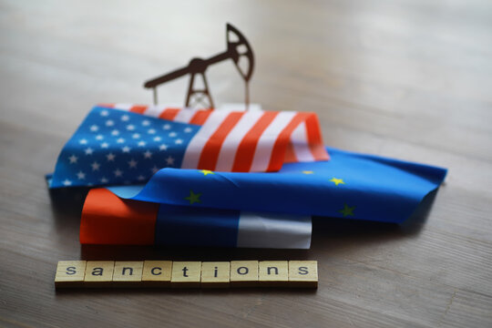 Oil Pump Silhouette, USA, EU, Russia Flags, and Sanctions Concept