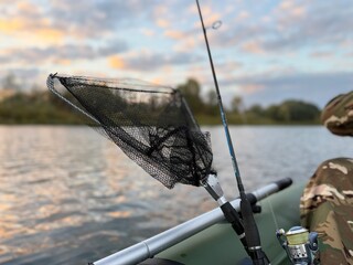 Fishing landing net and rod mounted on a boat close up © nadyarakoca