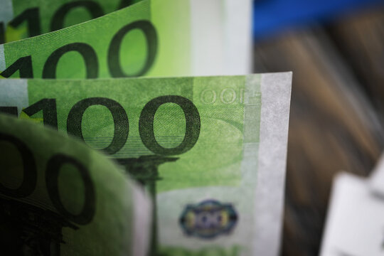 100 euro banknote pack and wood bankground. Currency, financial