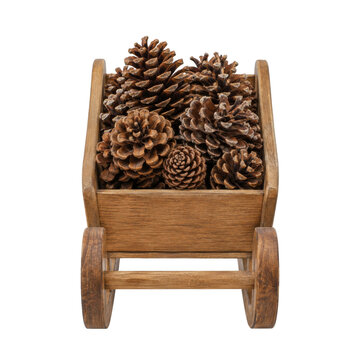 Rustic wooden wheelbarrow filled with natural brown pine cones isolated on white background