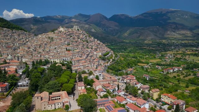Morano Calabro Calabria Italy 4k drone view of dense medieval hilltop village. Authentic untouched traditional italian borgo hidden gem pan of valley, monastery and mountains b-roll establishing video
