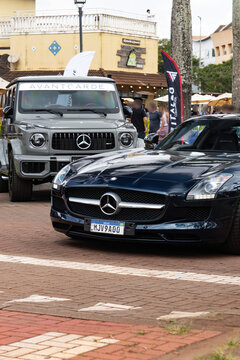 Dark Blue Mercedes Benz SLS AMG Supercar Front View Low Angle On Paved Plaza Outdoor Event Street