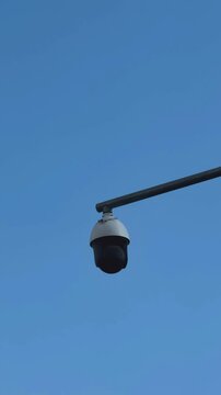 Security Camera Mounted on Pole Against Blue Sky
