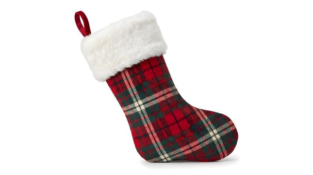 A festive red plaid christmas socks decoration isolated on white background with a christmas candy stick nearby